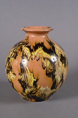 a vase that has a brown and black design on it
