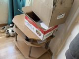a cardboard box sitting on top of a shelf in the corner of a room