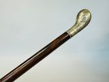 a close up of a walking stick with a wooden handle