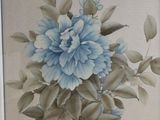 a picture of a painting of a blue flower on the wall