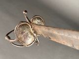 a close up of a metal object with a butterfly on it