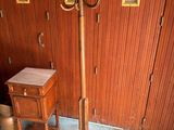 a coat rack that is standing in front of a wall