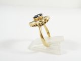 a close up of a gold ring with a blue stone on it