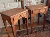 two tables that are sitting on a rug in a room