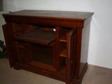 a small wooden cabinet with a shelf on top of it