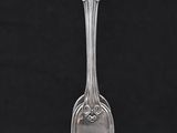 a silver spoon with a handle on a black background