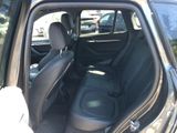 a black car with the back seats down and the door open