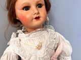 a close up of a doll with a dress on