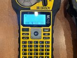 yellow and black cell phone sitting on top of a table next to other items