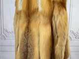a close up of a fur coat on a mannequin stand