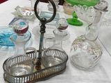 many glass items on a table with a white table cloth