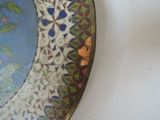 a close up of a decorative plate on a table