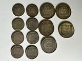 six different types of coins sitting on top of a white surface