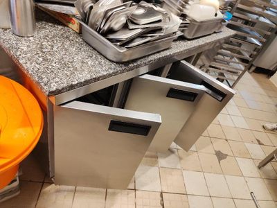 une cuisine avec beaucoup d'ustensiles posés sur le plan de travail