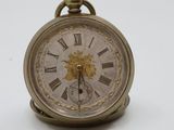 a small clock that is sitting on a white surface