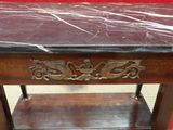 a table with a marble top and a wooden shelf
