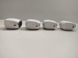 four small white objects sitting on a white surface