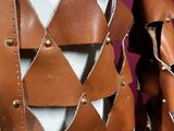 a close up of a brown leather jacket with metal studding on it