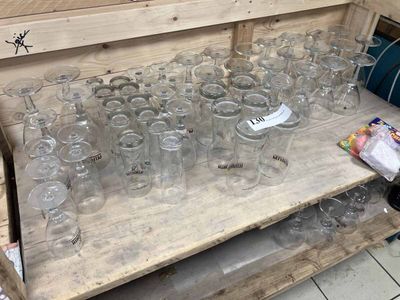 many empty glasses on a wooden table in a room