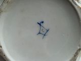 a white vase with a blue bird on it