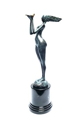 statue of a woman holding a bird in her hand on a pedestal