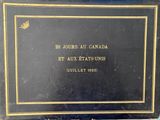 an old book with a gold border and a black cover
