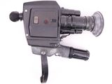 a black camera on a white surface with a white background