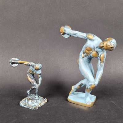 two figurines of a man and a woman on a table