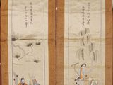 two chinese scroll paintings on display in a room