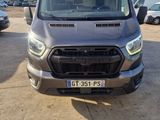 the front of a gray van parked in a parking lot