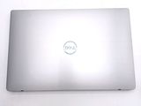 dell laptop computer sitting on a white surface with a dell logo on the screen