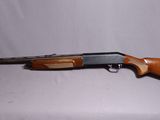 a shotgun that is sitting on top of a table