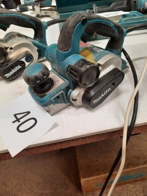 two electric tools are sitting on a table in a workshop