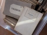 a stack of old books in a plastic box