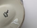 a close up of a cup with a handle on a table