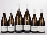 six bottles of wine are lined up in a row on a table