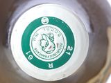 a close up of a bottle of beer with a green label on it
