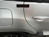 a close up of a car door with a red light on it