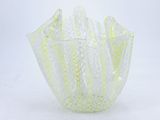 a glass vase that is sitting on a white surface