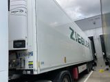 a large white truck that is parked in a lot