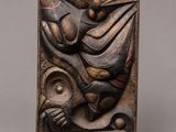 a wooden plaque with a bird and a fish on it