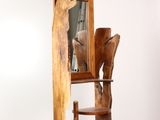 a wooden chair with a mirror on it in a room