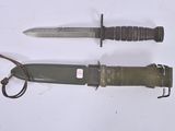 two knives that are laying side by side on a table