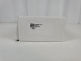 a white box with a sticker on it sitting on top of a table