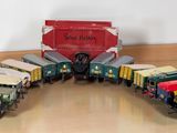 many toy trains that are sitting on the floor