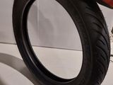 someone is holding a tire with a rubber glove on top of it