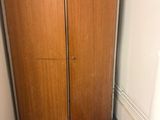 two wooden doors in the corner of a room