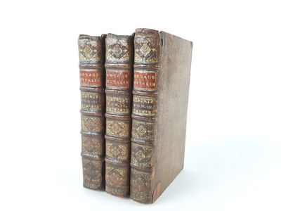 three books sitting on top of each other on a white surface