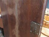 a wooden cabinet with a metal latch on the door