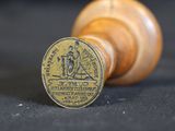 an old wooden stamp with a brass stamp on it